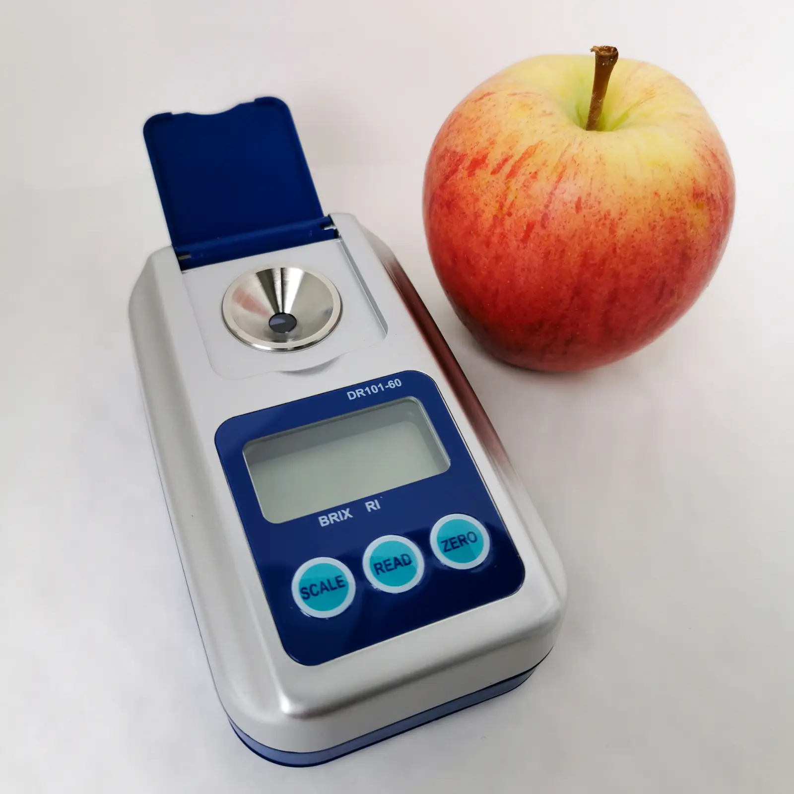 Digital Brix refractometer beside an apple