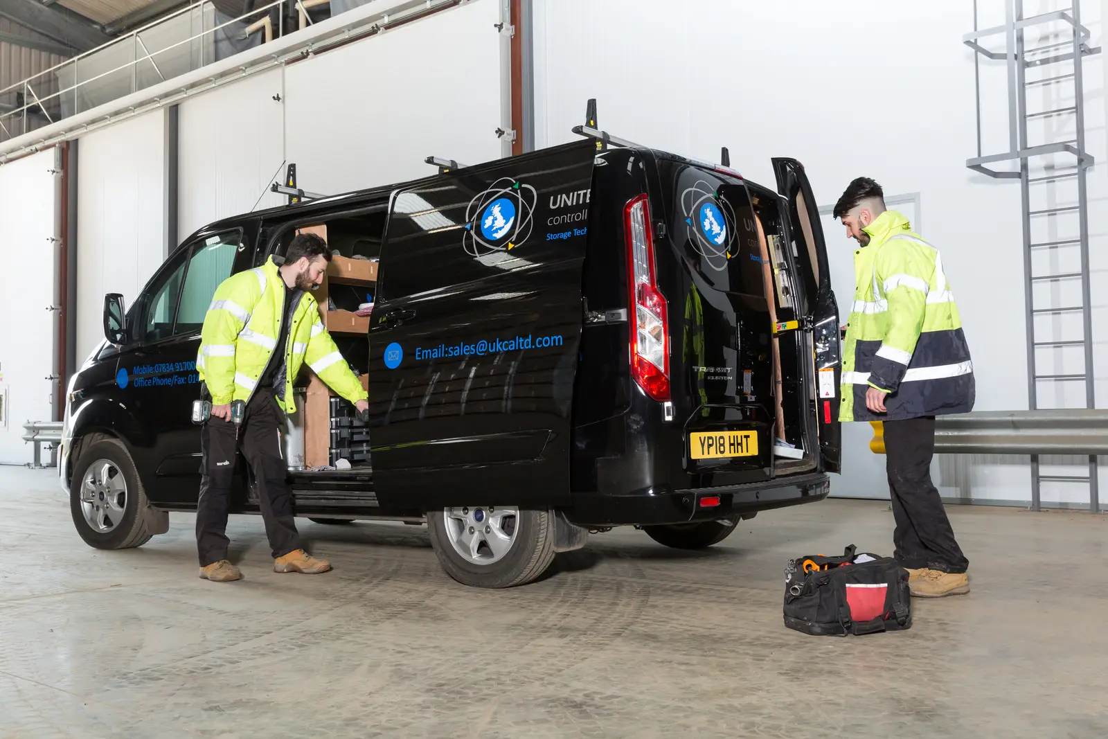 UKCA engineers unloading kit from the service van
