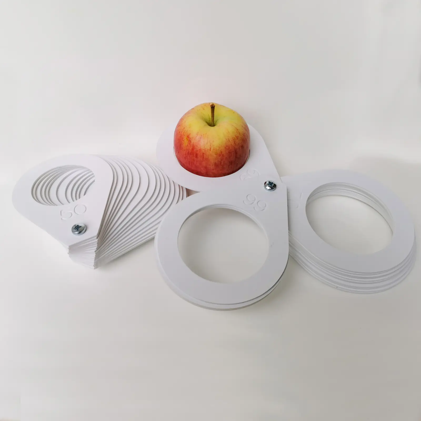 UKCA plastic sizing rings with an apple